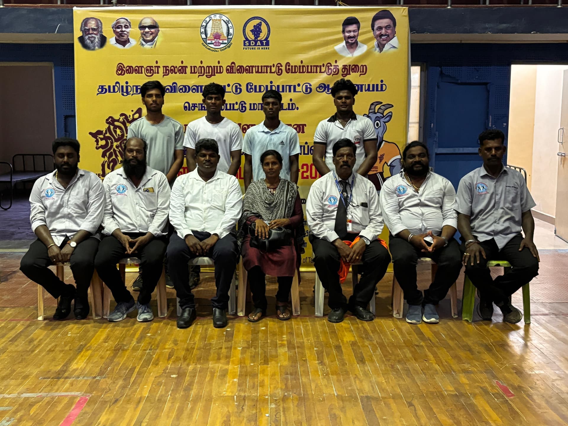 Indoor martial arts stage demonstration with students presenting at formal event
