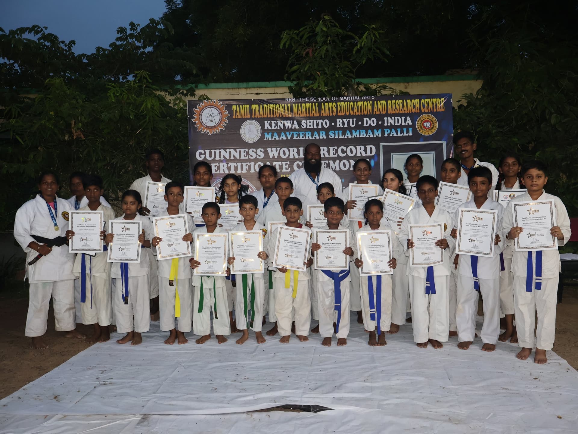 Large group photo of martial arts students celebrating Guinness World Record achievement