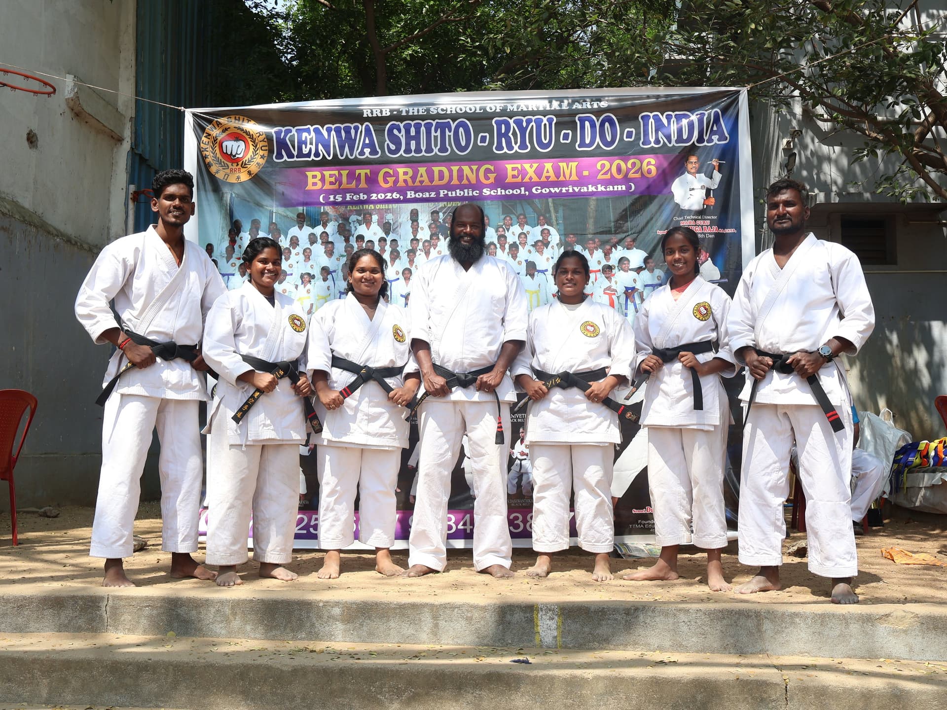 Karate students receiving belt promotions during formal grading ceremony