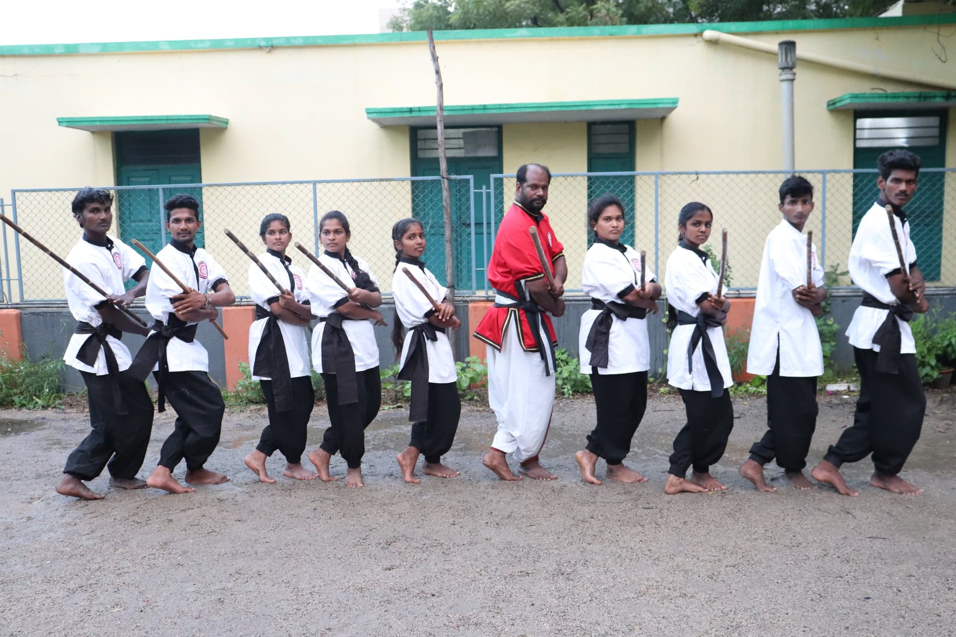 Annual silambam belt grading ceremony with students displaying certificates and achievements