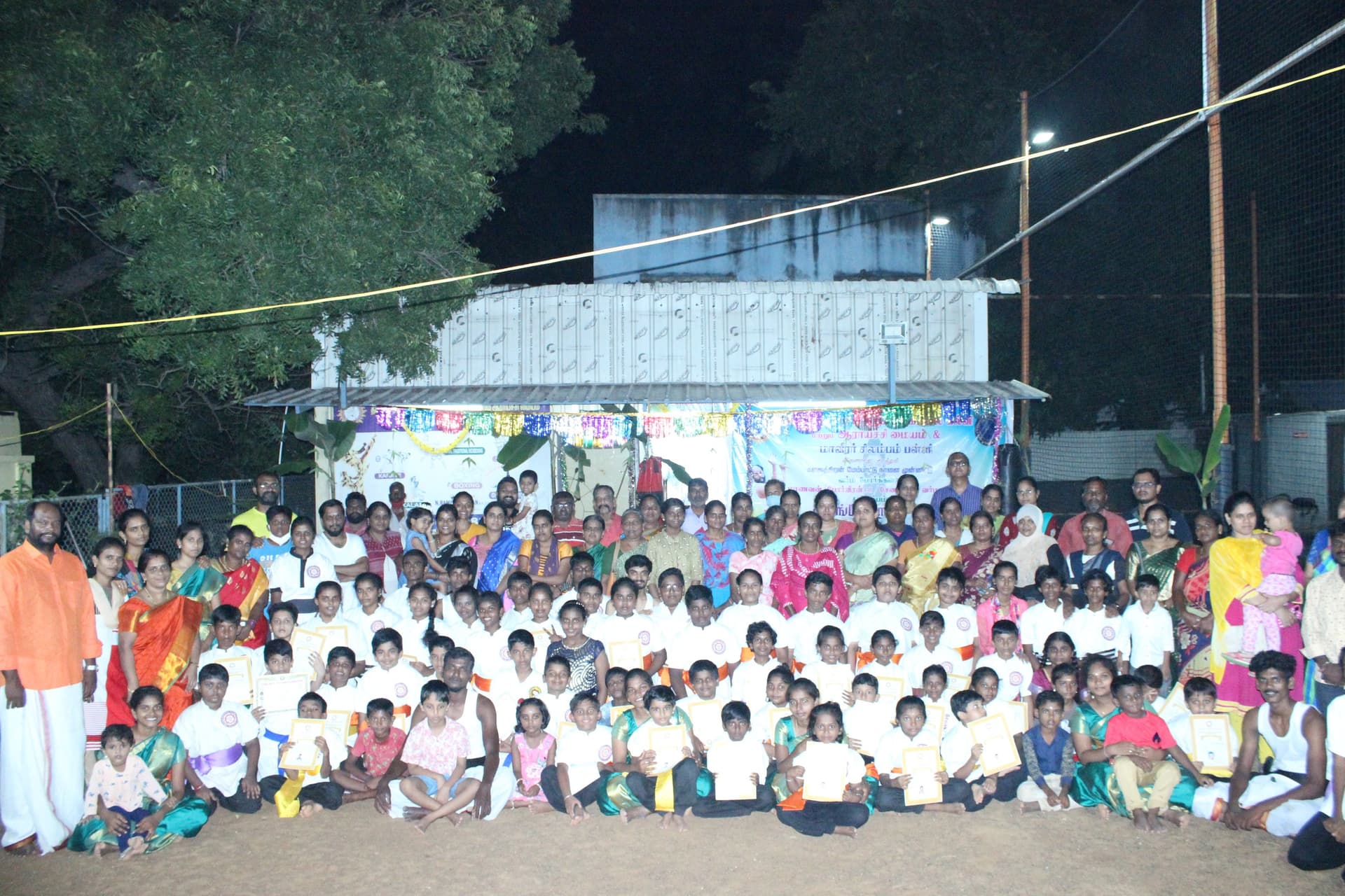 Silambam martial arts group event with students and instructors in traditional attire