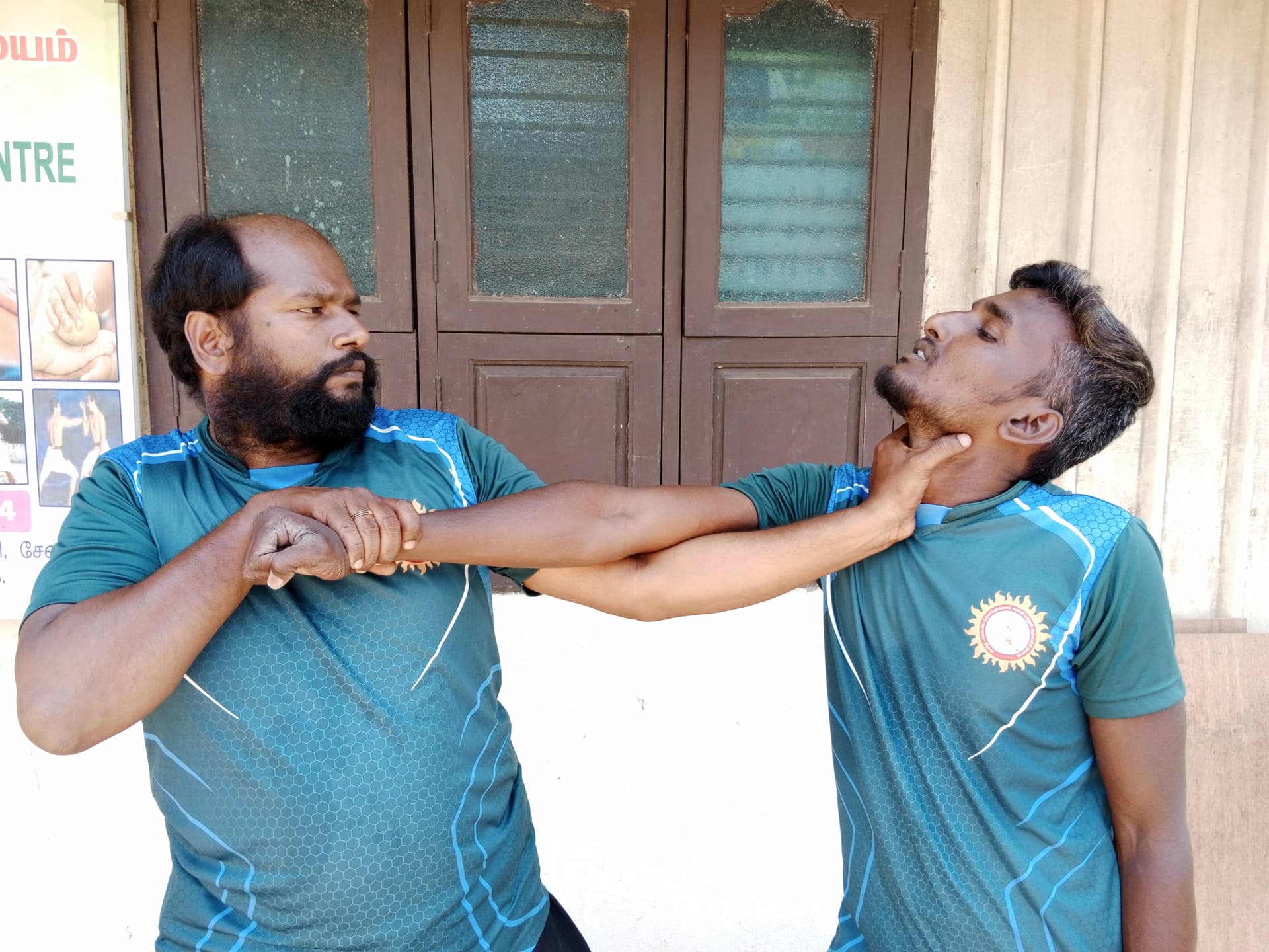 Students practicing traditional Tamil silambam staff fighting techniques during training session